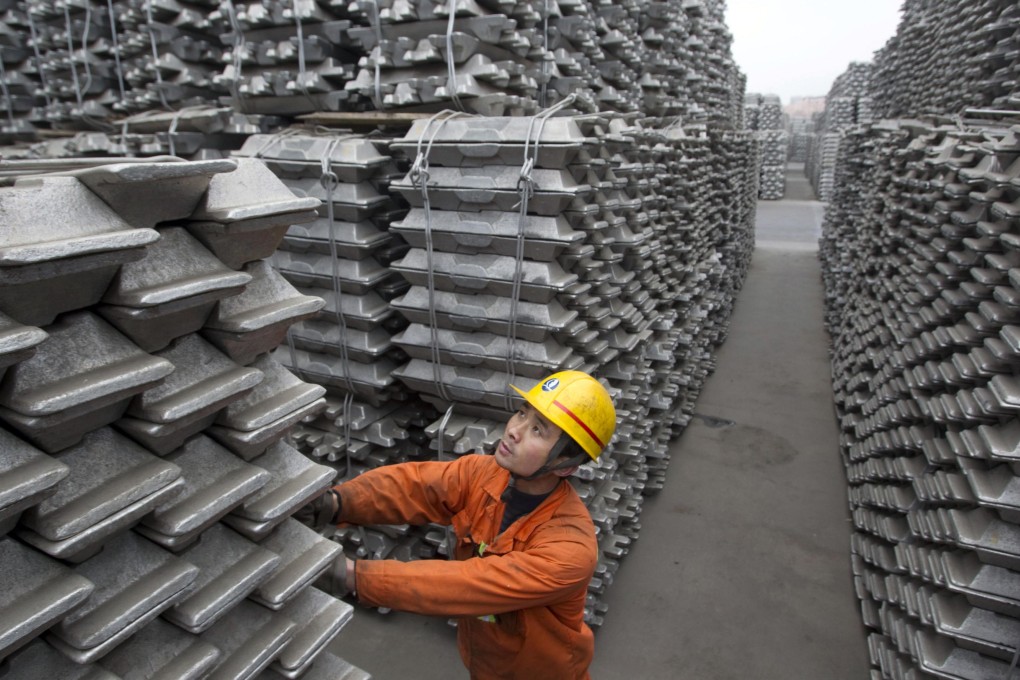 An employee checks aluminium ingots for export at Qingdao Port. Photo: Reuters