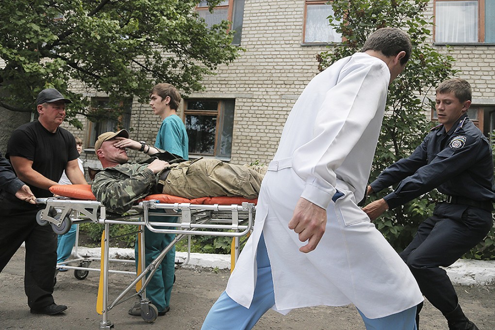 A wounded Ukrainian soldier is rushed to a hospital near Slovyansk. Photo: AP