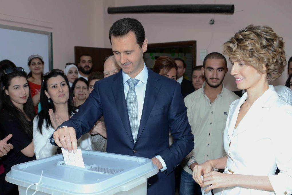 Bashar Al-Assad and his British-born wife Asma cast their ballots in Damascus as rebel mortars fall on the capital. Photo: EPA