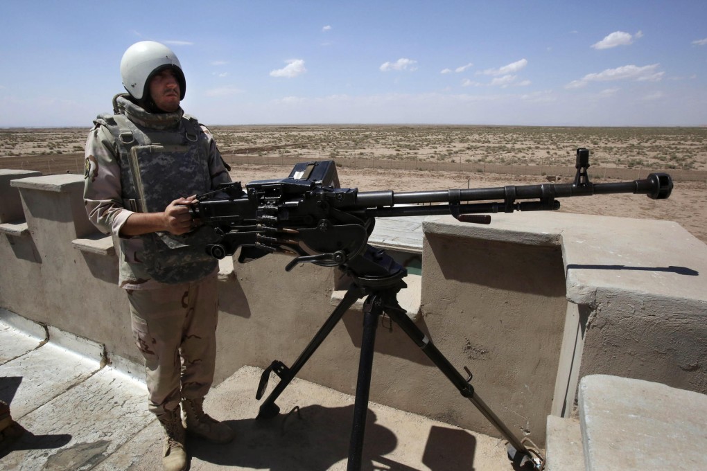 An Iranian policeman stands guard on the Afghan border. Photo: AP