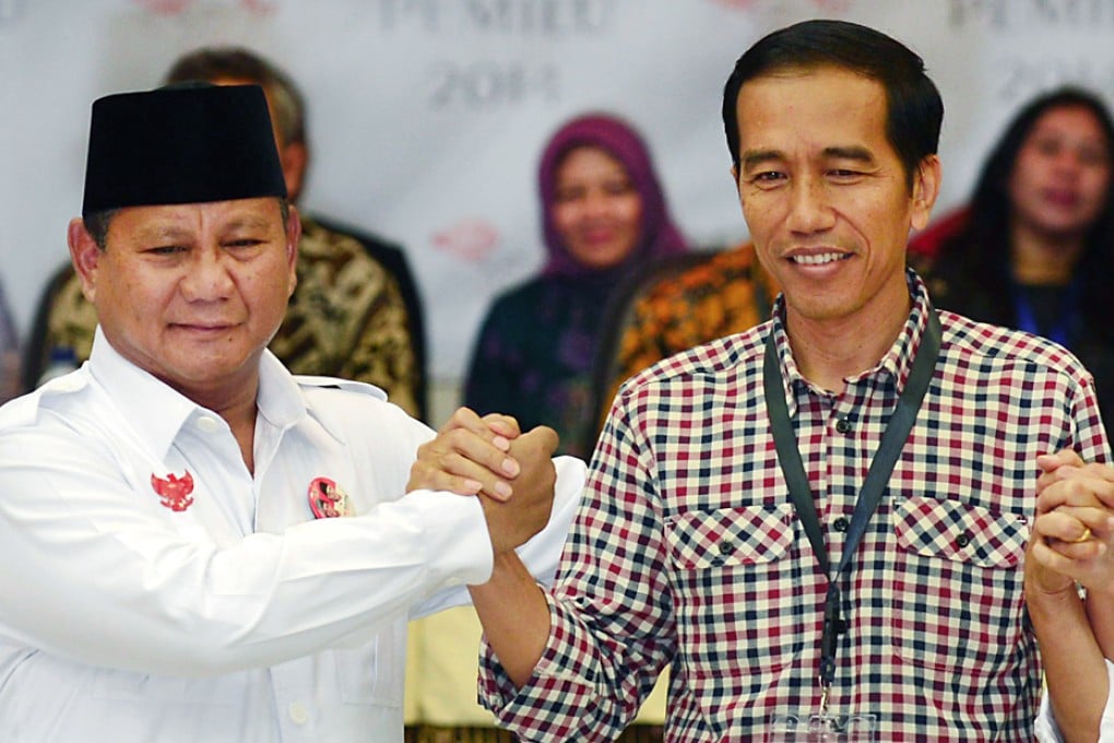 Indonesian presidential candidates Prabowo Subianto (left) , presidential candidate for the Gerindra party, shakes hand with Joko Widodo, who is favourite in the July 9 poll and represents the Indonesian Democratic Party of Struggle. Photo: AFP