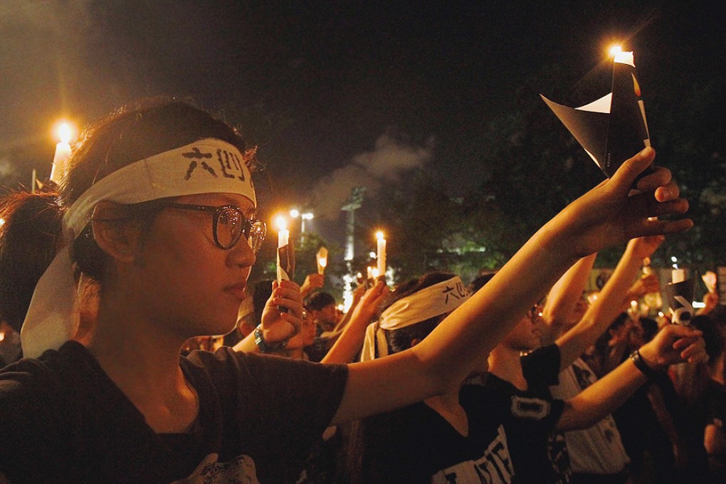 Members of the public at Wednesday night's vigil wear headbands similar to those worn by hunger strikers in 1989. Photo: Reuters