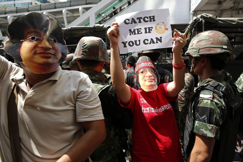 Protesters in Bangkok wear Sombat masks. Photo: EPA