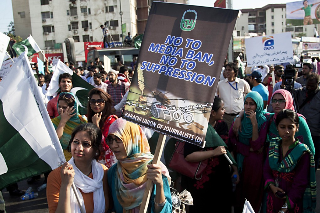 Employees of Pakistani Geo News TV channel rally in Karachi, Pakistan in May. The TV has run accusations against the military spy agency, blaming it for an "assassination attempt" against the station's popular talk show host, Hamid Mir, who was shot and wounded in Karachi. Photo: AP