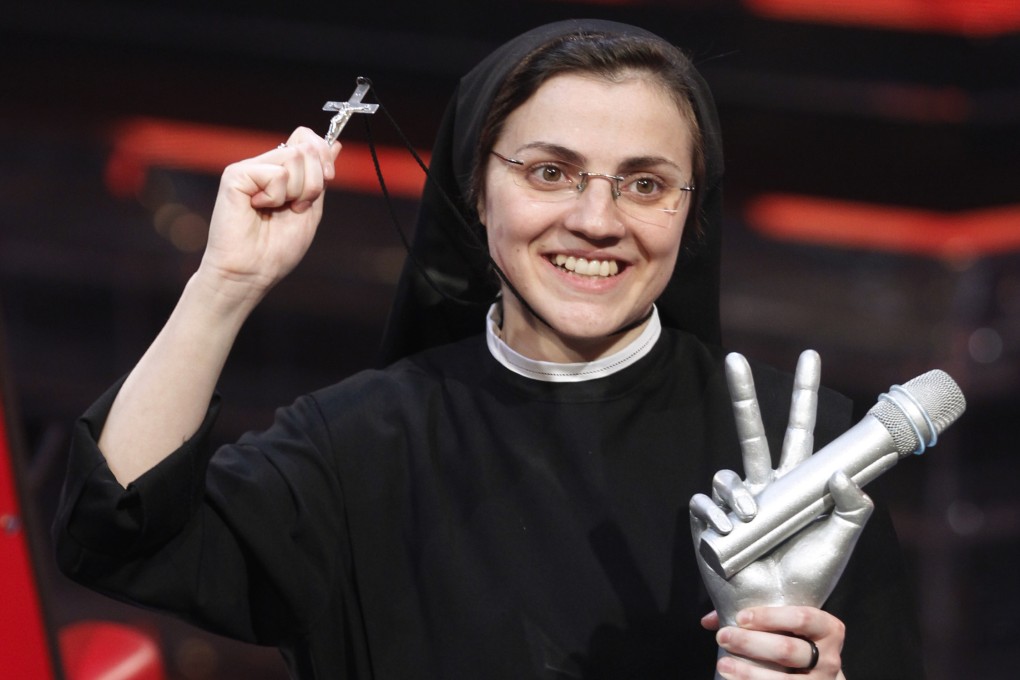 Sister Cristina Scuccia poses with the trophy after winning The Voice of Italy. Photo: AP