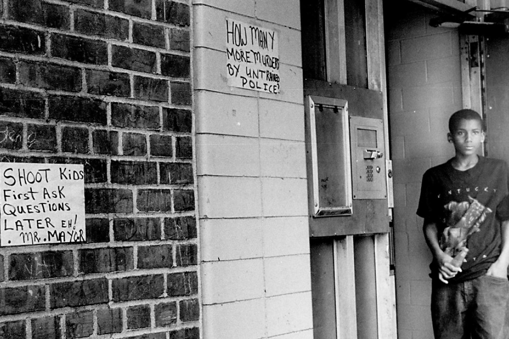 Ronald Herron in 1994, 12, stands in the doorway of the Gowanus Houses in New York. Now 32 and sometimes known as the Rapper "Ra Diggs" Herron is on trial for murder in New York. Photo: AP