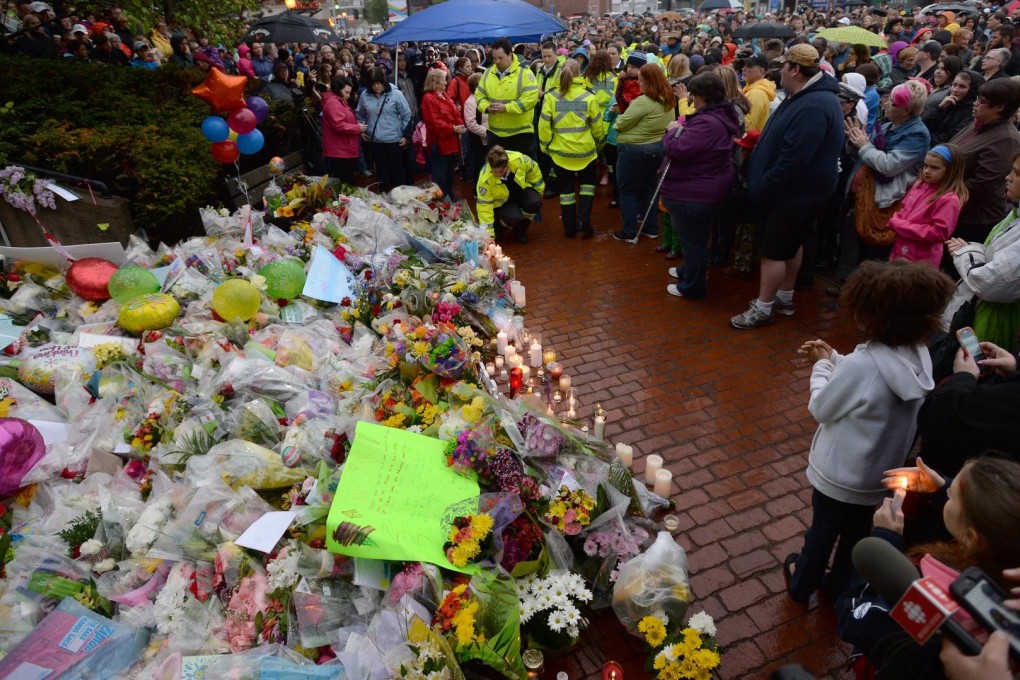 Floral tributes at the Mounties headquarters in Moncton at a candelight vigil for the three murdered officers. Photo: AP