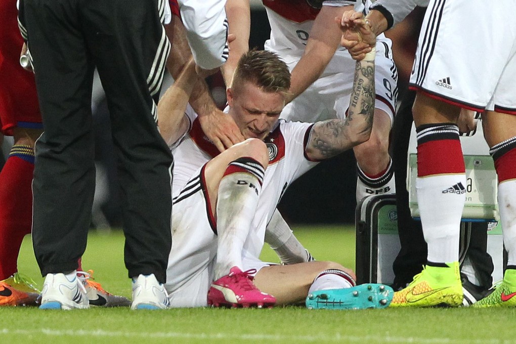 Reus had to be helped off the pitch after suffering an ankle injury in Friday's warm-up match against Armenia. Photo: AFP