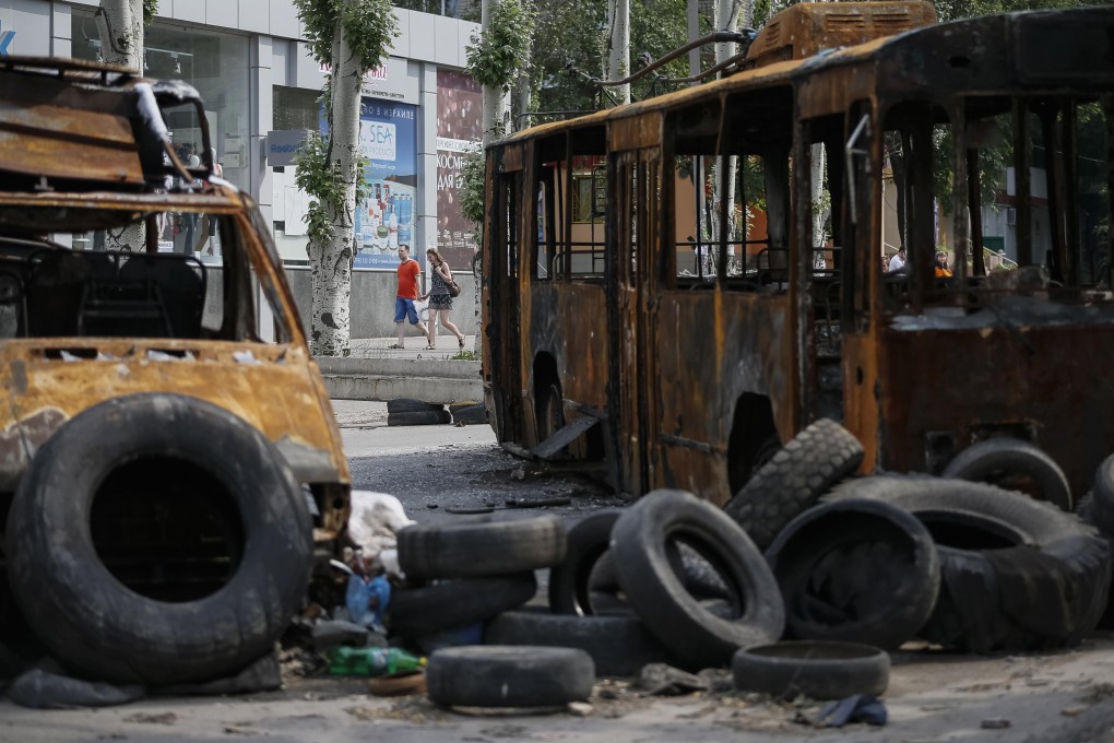 Local residents pass in central town of Kramatorsk. Photo: Reuters