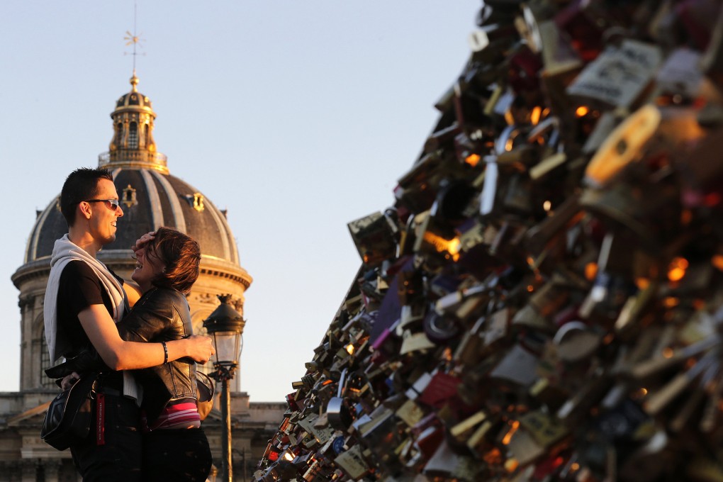 The full 150-metre length of the Pont des Arts is covered in locks, and the practice has spread to other bridges around Paris. Photo: Reuters