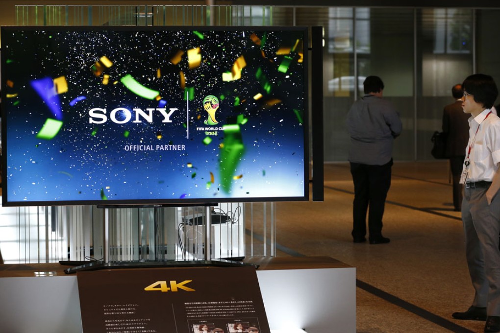 A visitor watches a Sony's 4K flat-panel television on display at the Sony headquarters in Tokyo. Photo: AP
