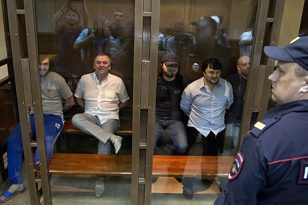 From left: Ibragim Makhmudov, Lom-Ali Gaitukayev, Dzhabrail Makhmudov, Rustam Makhmudov and Sergey Hadjikurbanov  await the judge's verdict at Moscow City Court. Photo: AP