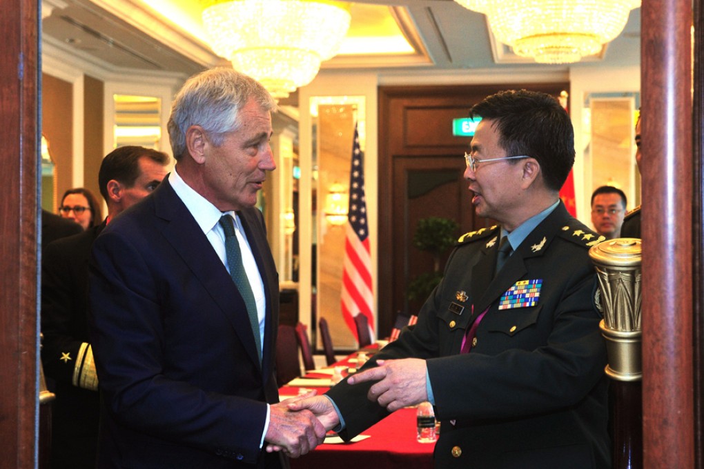 Wang Guanzhong (right) shakes hands with Chuck Hagel at the Shangri-La Dialogue in Singapore. Photo: Xinhua