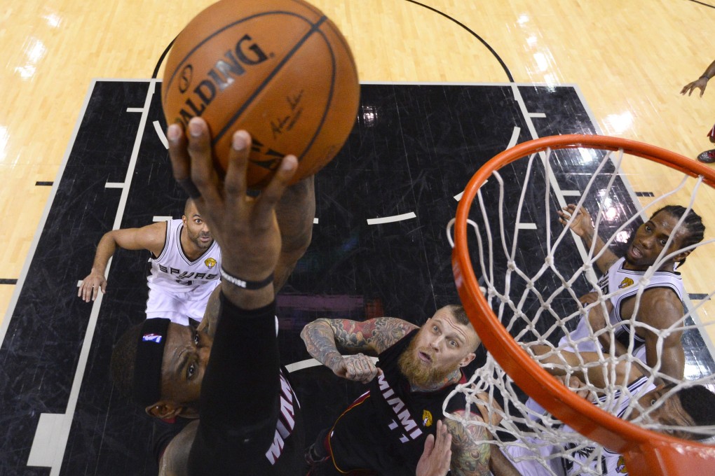 Miami Heat forward LeBron James goes to the basket to score against the San Antonio Spurs. Photo: EPA