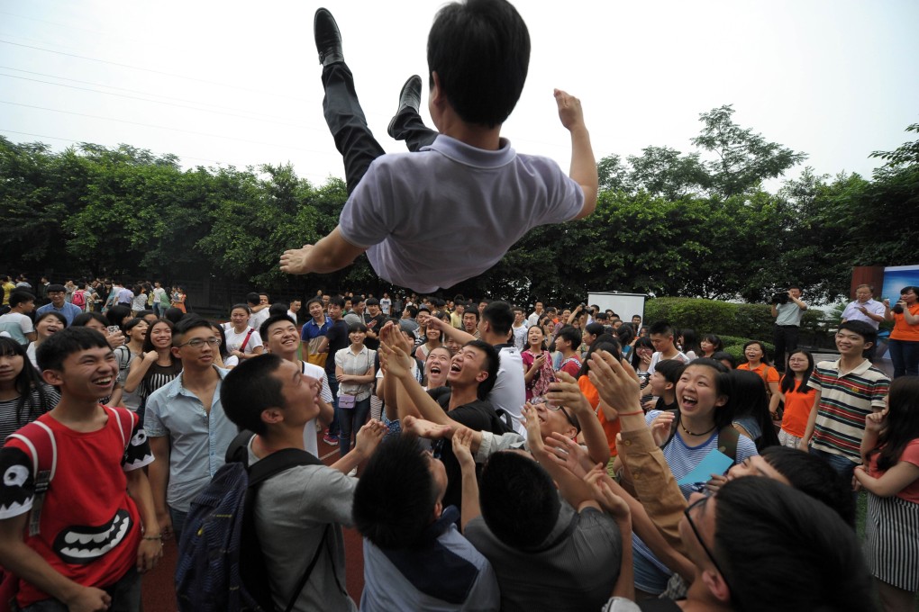 High school students throwing their teacher into the air during a graduation ceremony after the 2014 college entrance exam of China in a school in Chongqing. Photo: AFP