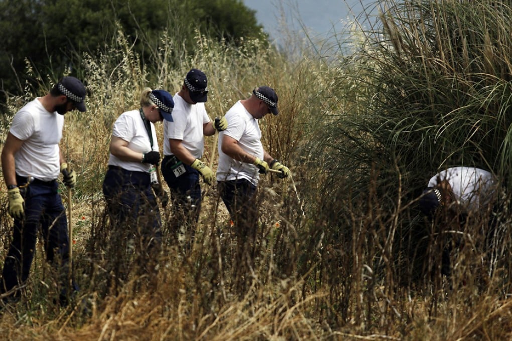 British police using sticks search dense scrubland in Praia da Luz for clues to the disappearance of Madeleine McCann. Photo: AP