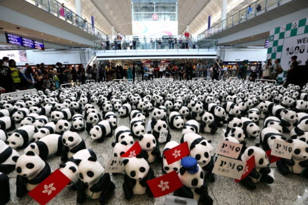 Some of the 1,600 papier-mâchè pandas meet their public at the airport before beginning a tour of the city and a spell at the PMQ arts centre in Central. Photo: Felix Wong