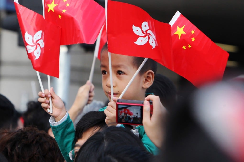 Members of the public gather at Golden Bauhinia Square in Wan Chai to watch the flag raising ceremony on National Day October 1, 2013. Photo: SCMP