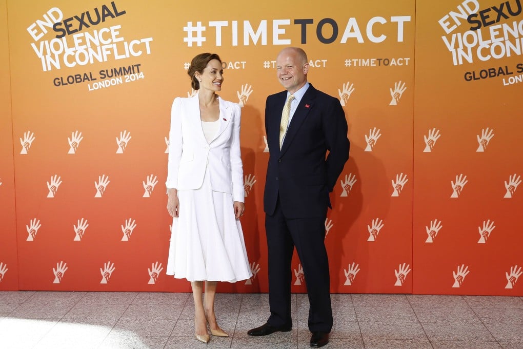 Angelina Jolie poses with British Foreign Secretary William Hague at a global summit to end sexual violence. Photo: Reuters