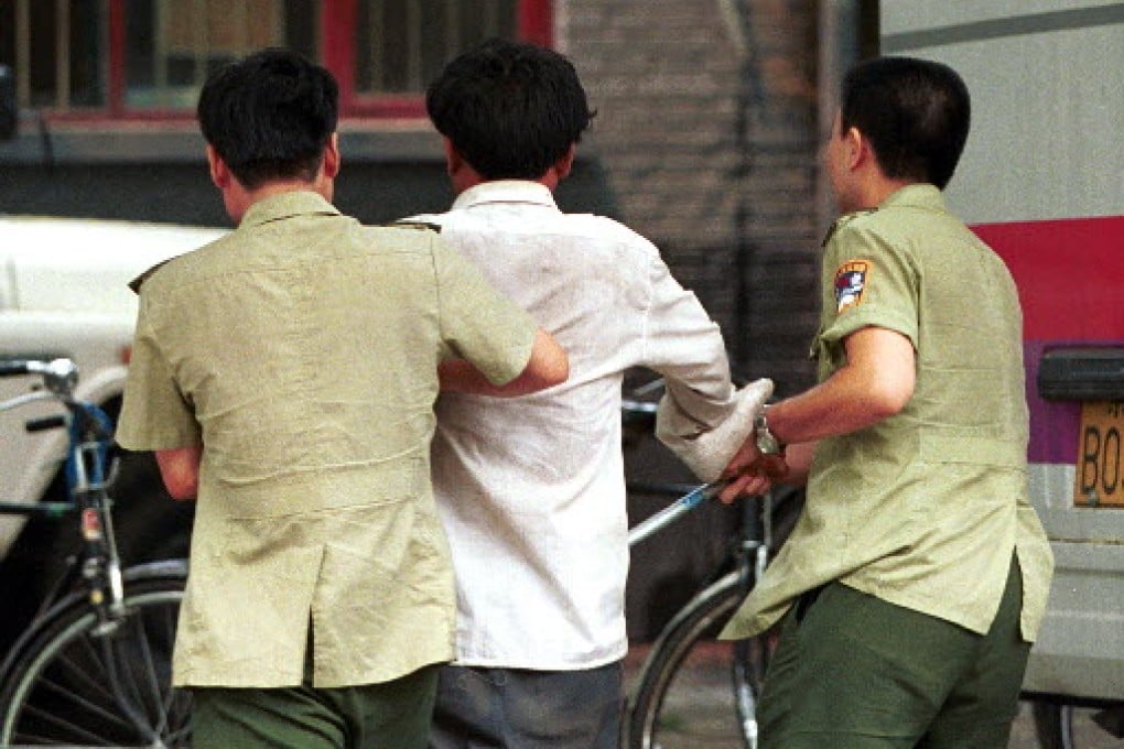 A member of the banned movement Falun Gong is arrested. Photo: AP