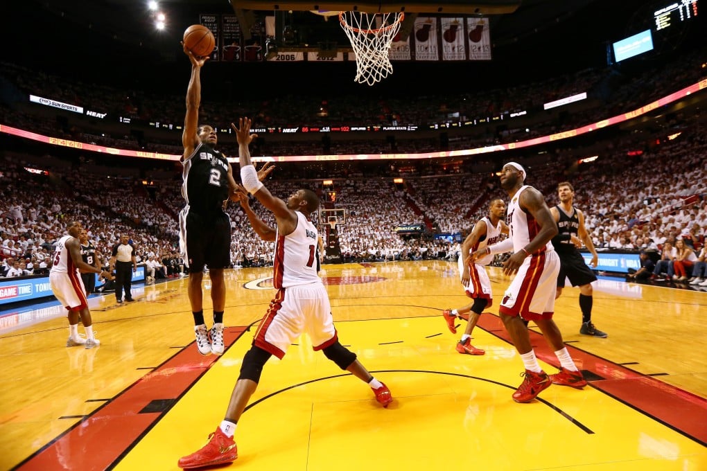 Kawhi Leonard, of the San Antonio Spurs, takes a shot over Chris Bosh during game three. Leonard led the Spurs with a career high 29 points in their 111-92 victory . Photo: AFP