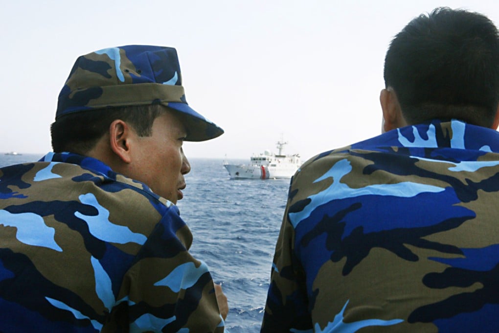 Officers of the Vietnamese Marine Guard talk as they monitor a Chinese coastguard vessel in the South China Sea, about 210km off the shore of Vietnam. Photo: Reuters