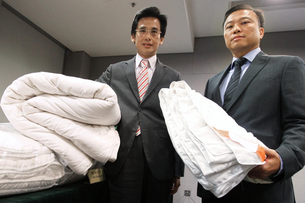 Officers with some of the quilts that may be in breach of the trade descriptions law.Photo: Edward Wong