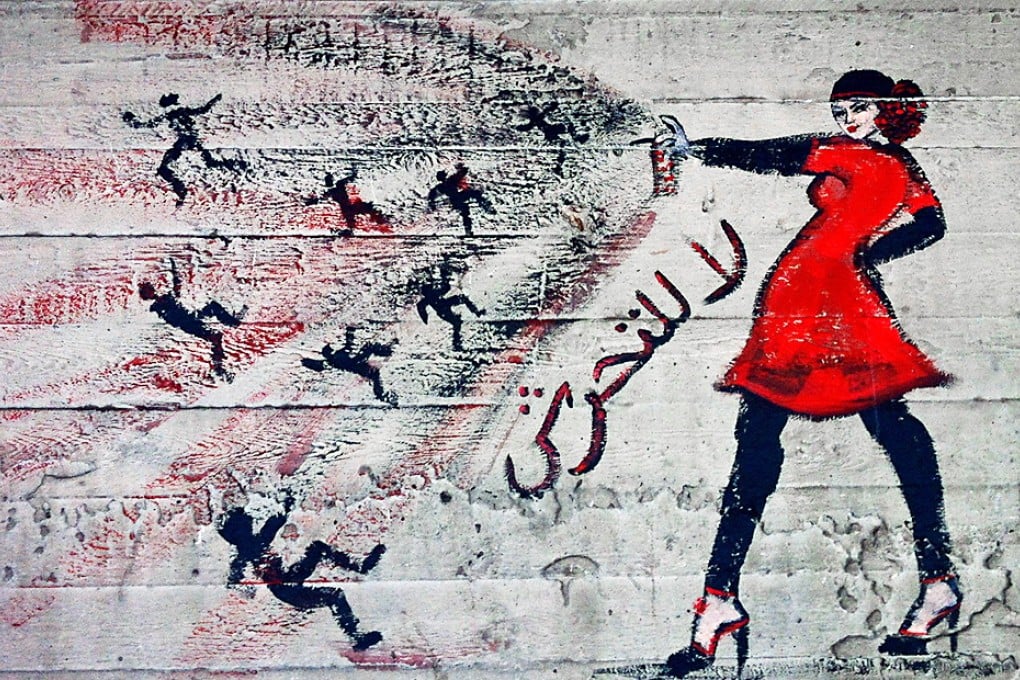 Graffiti on a wall in Cairo shows a woman with the words "no harassment" in Arabic. Photo: AP