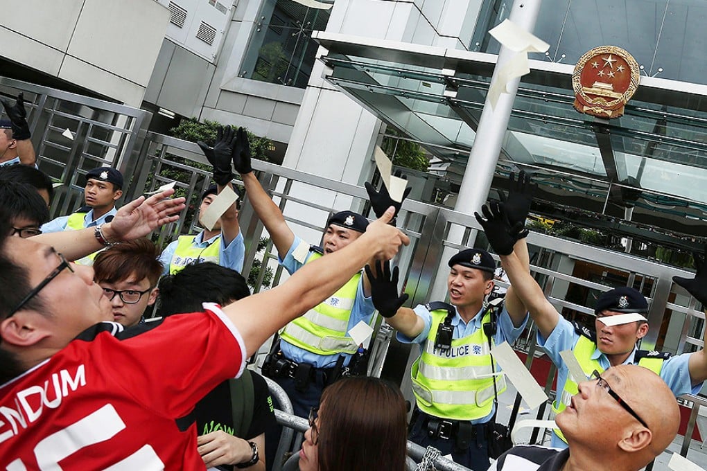 Members of the League of Social Democrats and other activists protest against the white paper outside the Liaison Office. Photo: Nora Tam