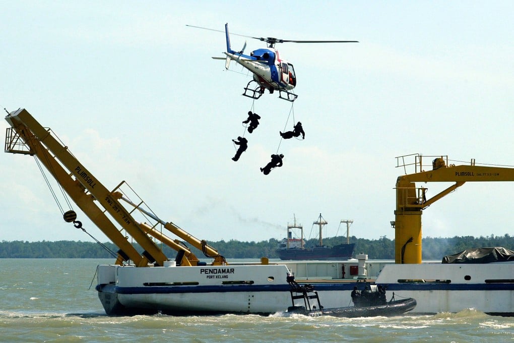 Malaysian special forces absail onto a vessel from a police helicopter during an anti-piracy demonstration in the Straits of Malacca in this file photo. Photo: AFP