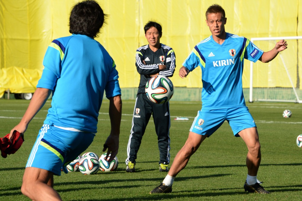 Japan's forward Keisuke Honda (right) goes through drills with teammates. Photo: AFP