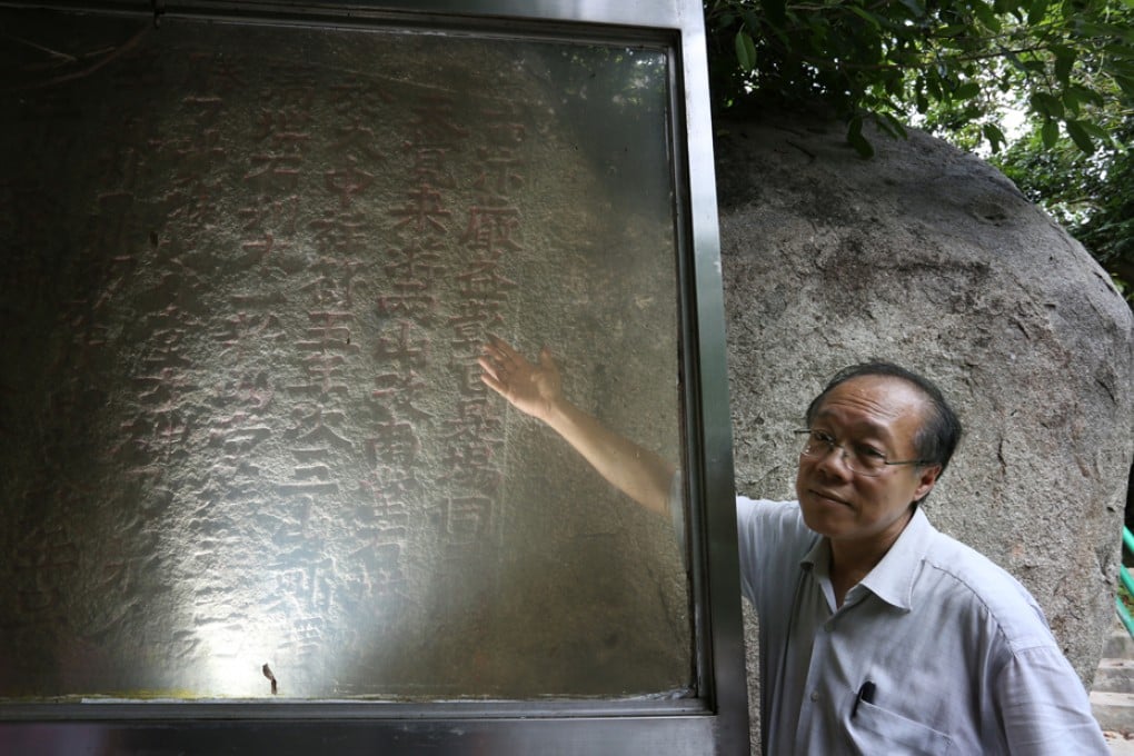 Chinese historian Ho Koon-wan explains the inscription dating back to the Song Dynasty. The declared monument in Sai Kung is the oldest dated inscription known in Hong Kong. Photo: Nora Tam