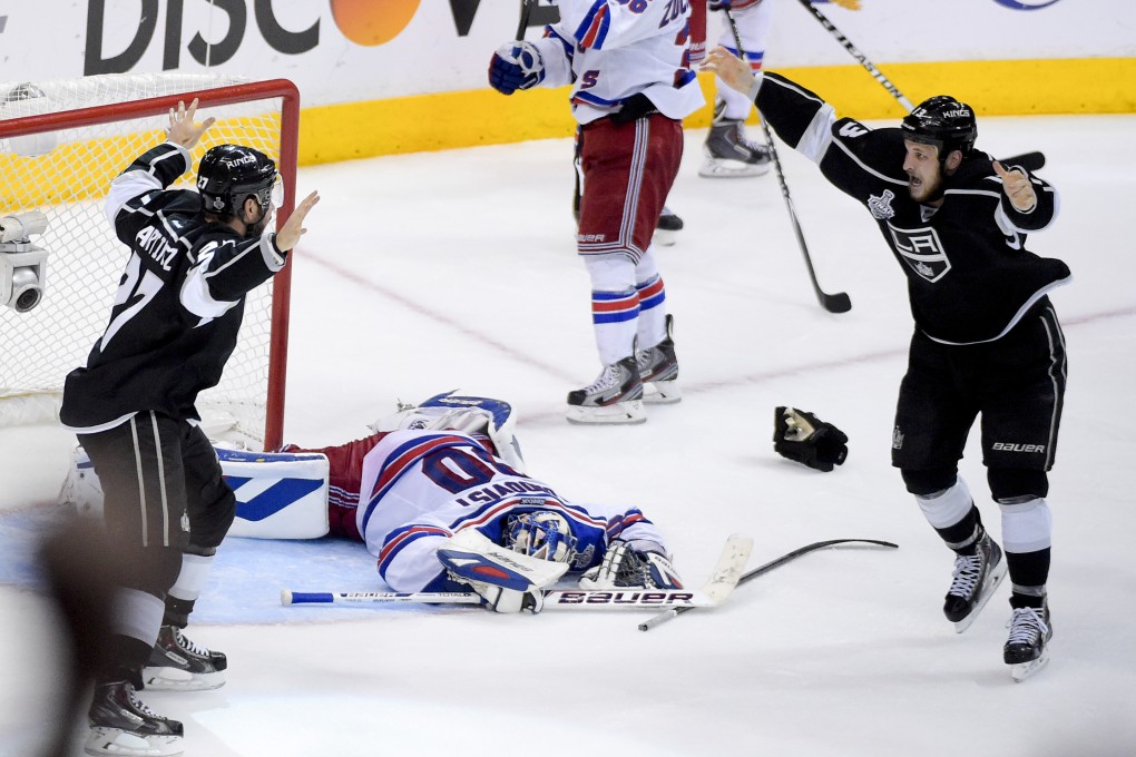 Los Angeles Kings defenceman Alec Martinez (left) celebrates with Kyle Clifford after scoring the winning goal past New York Rangers goalie Henrik Lundqvist in the second overtime period in game five. Photo: AP