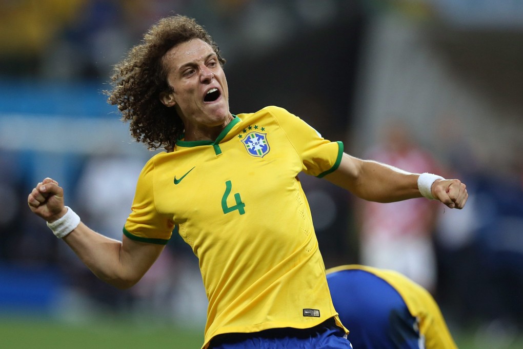 David Luiz, seen here celebrating Brazil's win over Croatia in the opening game of the World Cup, has joined Paris Saint-Germain. Photo: EPA