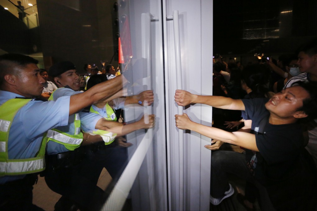 Activists clash with police outside Legco Building during Legco Finance Committee meeting. Photo: Felix Wong