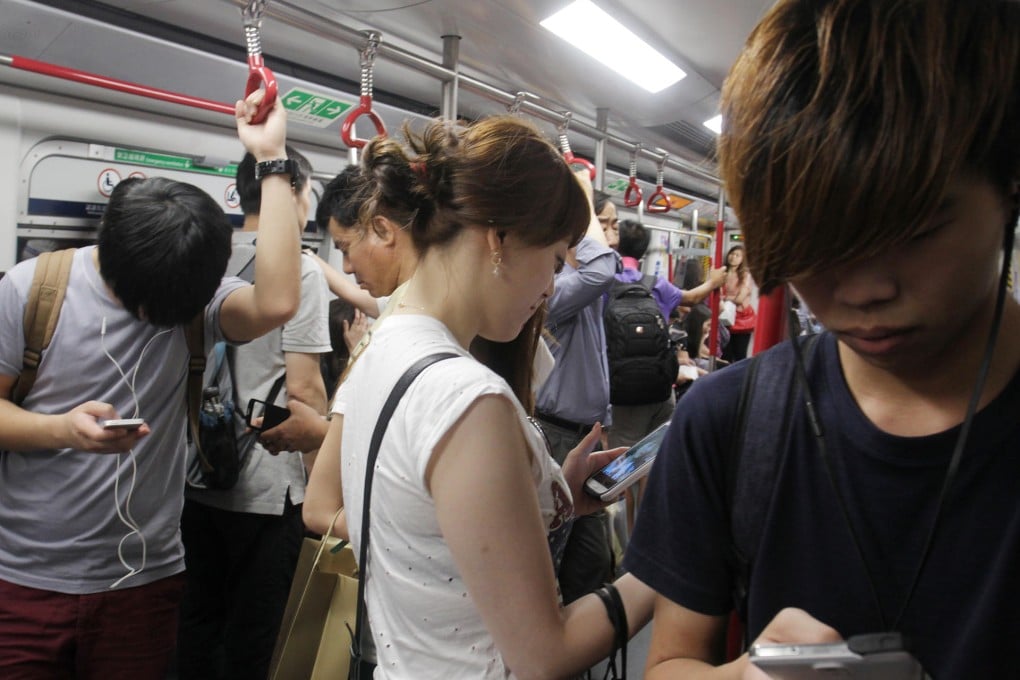 Some can't be separated from their smartphones. Photo: Dickson Lee