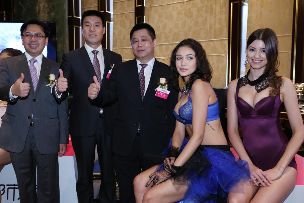 Cosmo Lady executives (from left) Yu Chun-kau, Zheng Yaonan and Zhang Shengfeng pose in Hong Kong yesterday with models wearing their products. Photo: Edward Wong