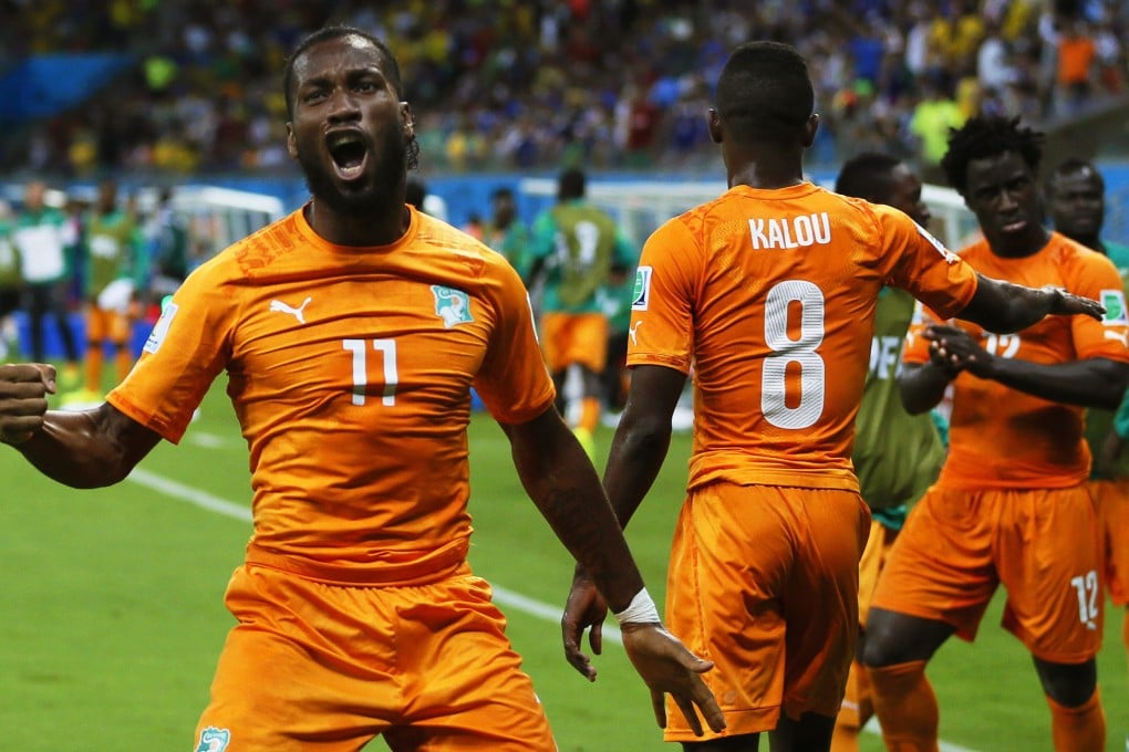 Didier Drogba and his Ivory Coast teammates celebrate a goal against Japan in their group C match. Photo: EPA