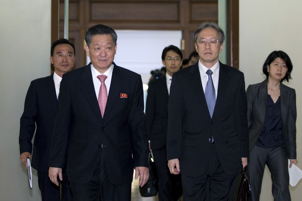 Junichi Ihara, centre right, and Song Il-ho are expected to come together for talks on reinvestigating the abductions. Photo: AP