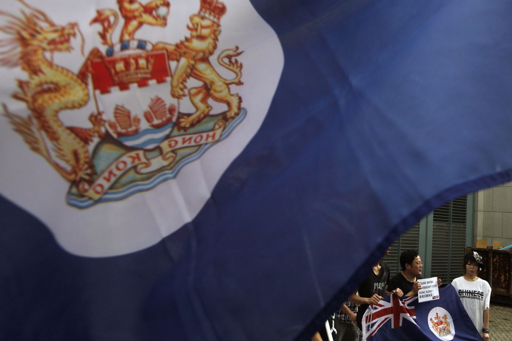 Protesters, carrying former Hong Kong colonial flags, demonstrate against China's intervention and control of the internal affairs of the former British colony, outside the British Consulate in Hong Kong. Photo: Reuters