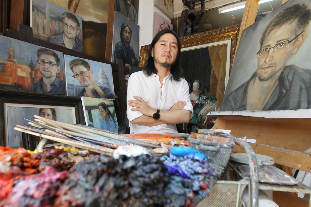 Dafen artist Huang Haifan in front of some or his portraits of NSA whistle-blower Edward Snowden. Photo: Edward Wong