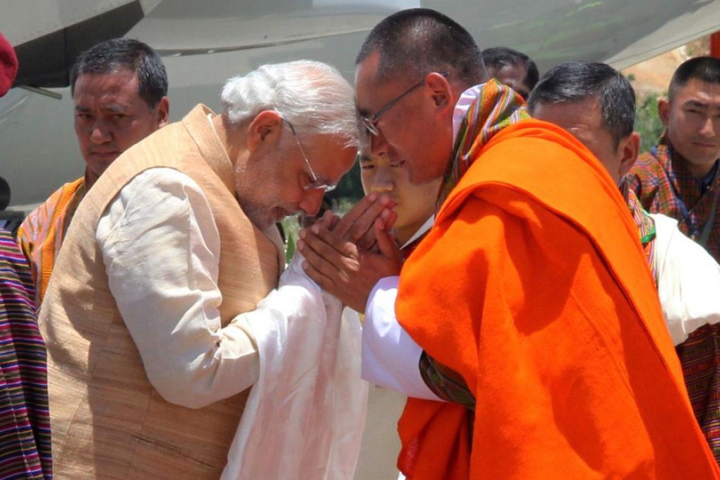 Indian Prime Minister Narendra Modi (left) is greeted by Bhutanese Prime Minister Tshering Tobgay at Paro Airport. Photo: AFP