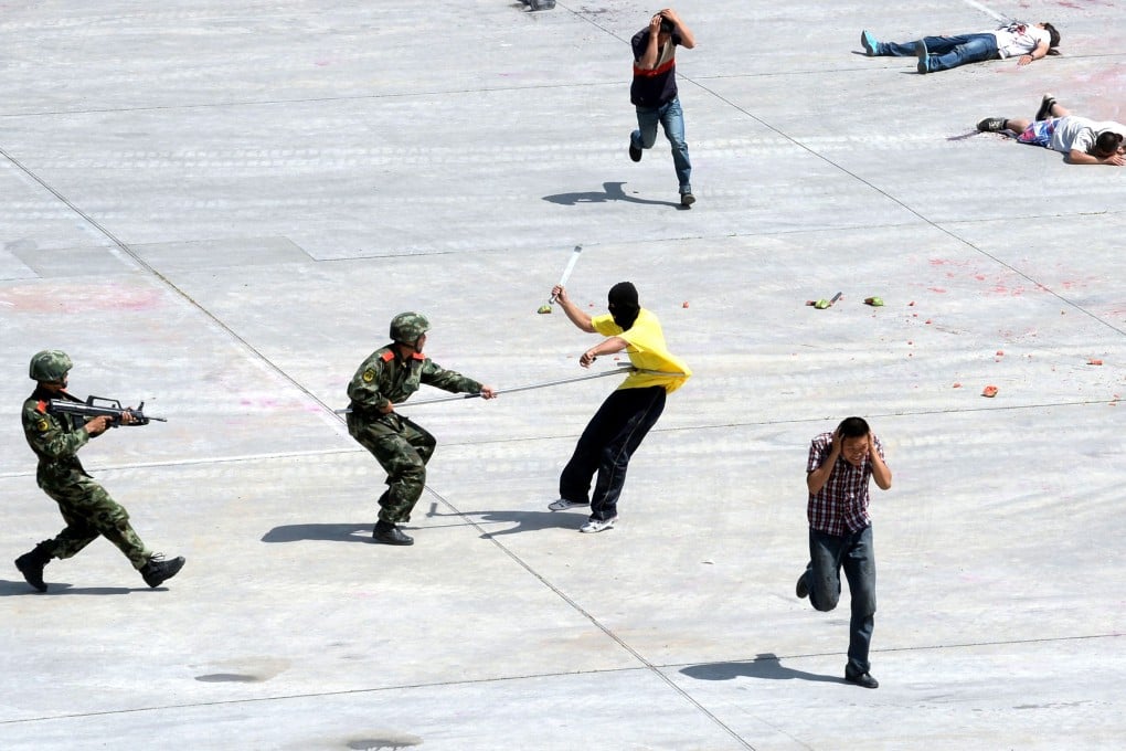 Police officers in Beijing demonstrate their skills at handling terror attacks in the wake of violence in Xinjiang. Photo: AFP