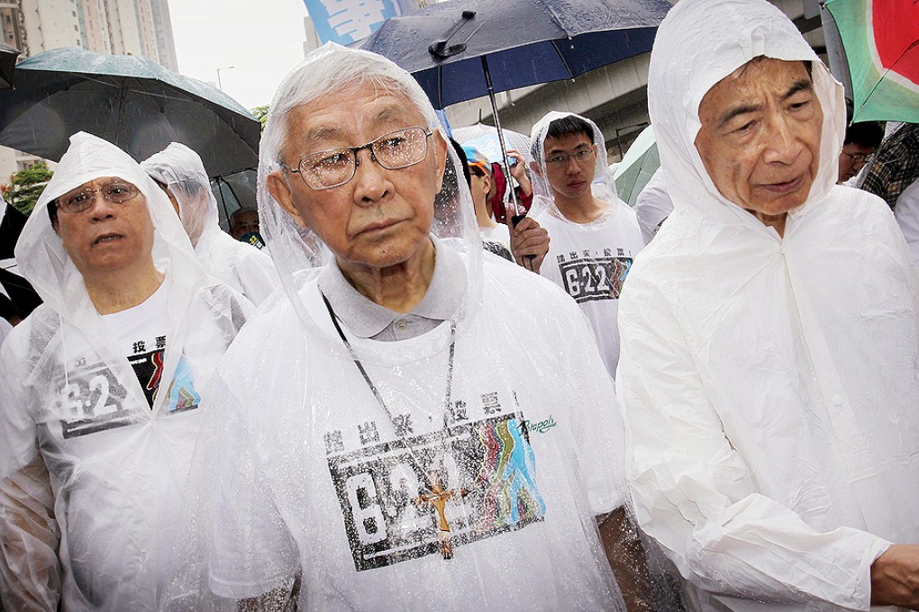 His glasses specked with rain, Cardinal Joseph Zen Ze-kiun, with activist Martin Lee Chu-ming by his side, take their message calling on people to vote in the Occupy Central "referendum" this week from Lam Tim to Lok Fu. Photo: Dickson Lee