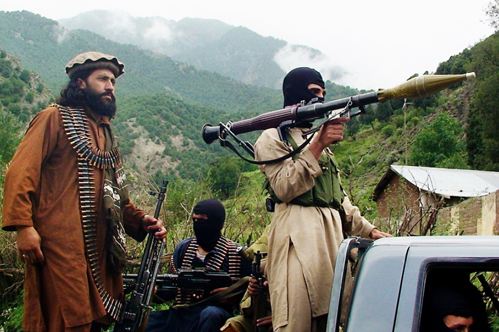 Pakistani Taliban patrol in their stronghold of Shawal in Pakistani tribal region of South Waziristan in 2012. Photo: AP