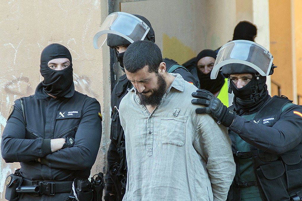 Spanish security forces arrest a suspected member of a jihadist cell Spain's north African territory of Melilla on May 30. Photo: AFP