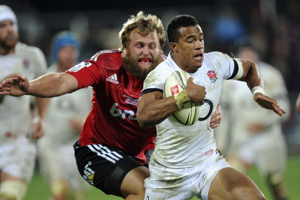 England's Anthony Watson outpaces Crusaders' Joe Moody in their match at Christchurch. Photo: AP