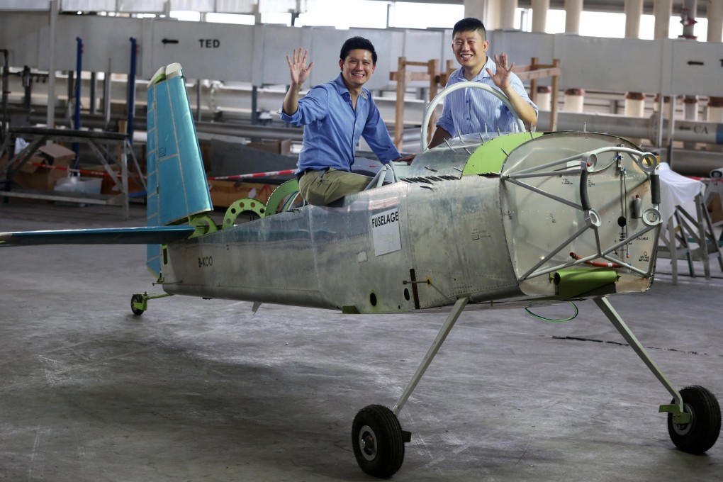 Pilots Jeremy Tam Man-ho (left) and Hank Cheng Chor-hang sit proudly on the near-completed kit plane at Chek Lap Kok. Photo: Nora Tam