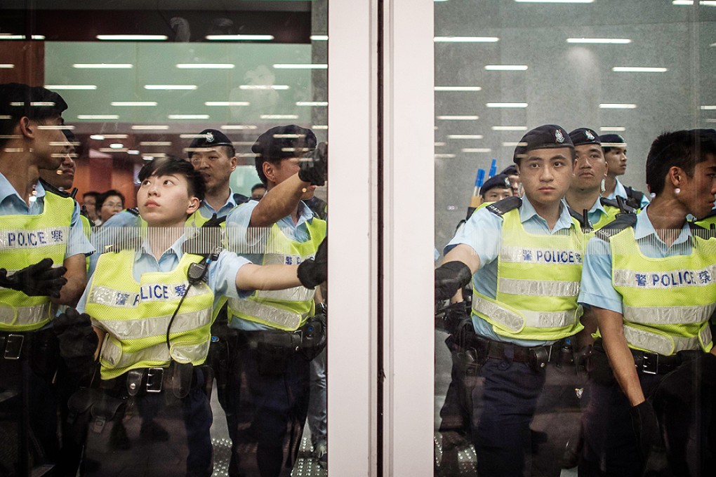 Police stand guard inside the Legco building last Friday. Photo: AFP