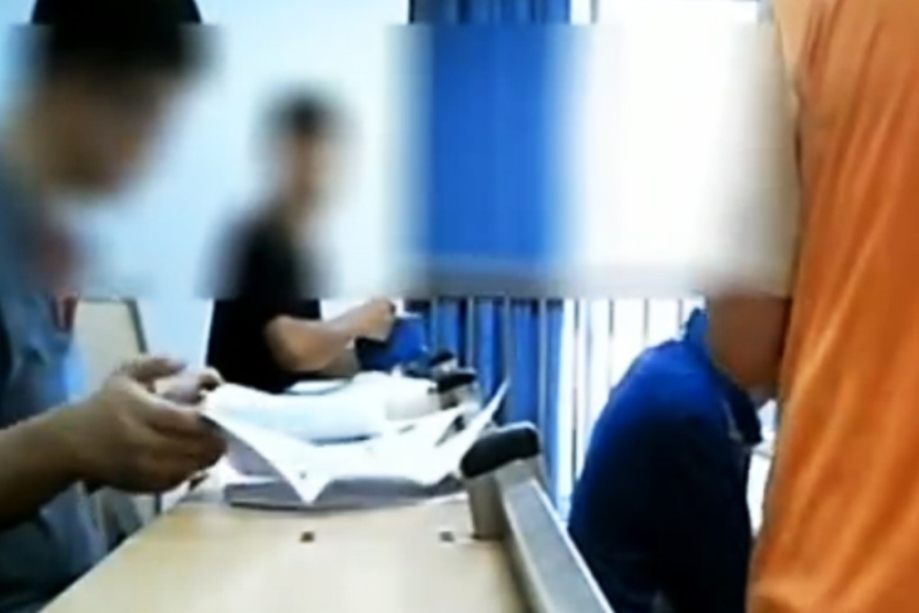 Recruits hoping to be hired to take the test in place of the high school students take a mock exam under Li. The recruits can be paid up to 50,000 yuan for their efforts. Photo: CCTV screengrab